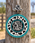 Cattle and Chaos round cardstock freshie with cow print and teal glitter border