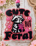 Cute But Feral raccoon car freshie in hot pink glitter